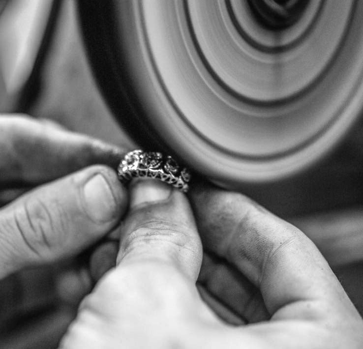 Goldsmith polishing a gold ring