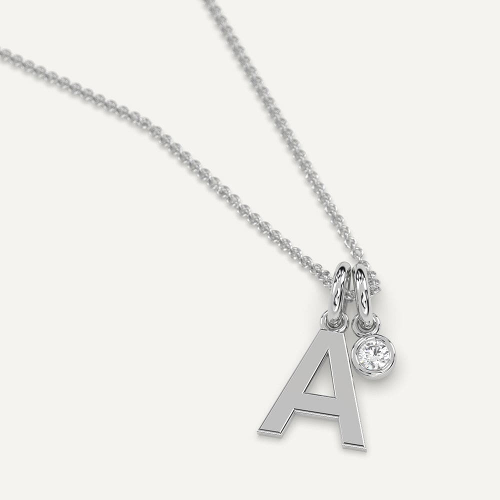 Gold necklace featuring an initial letter 'A' pendant adorned with sparkling diamonds.