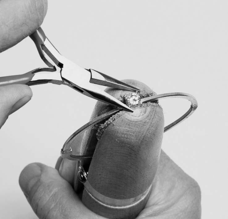 Jeweler tightening diamond in bracelet