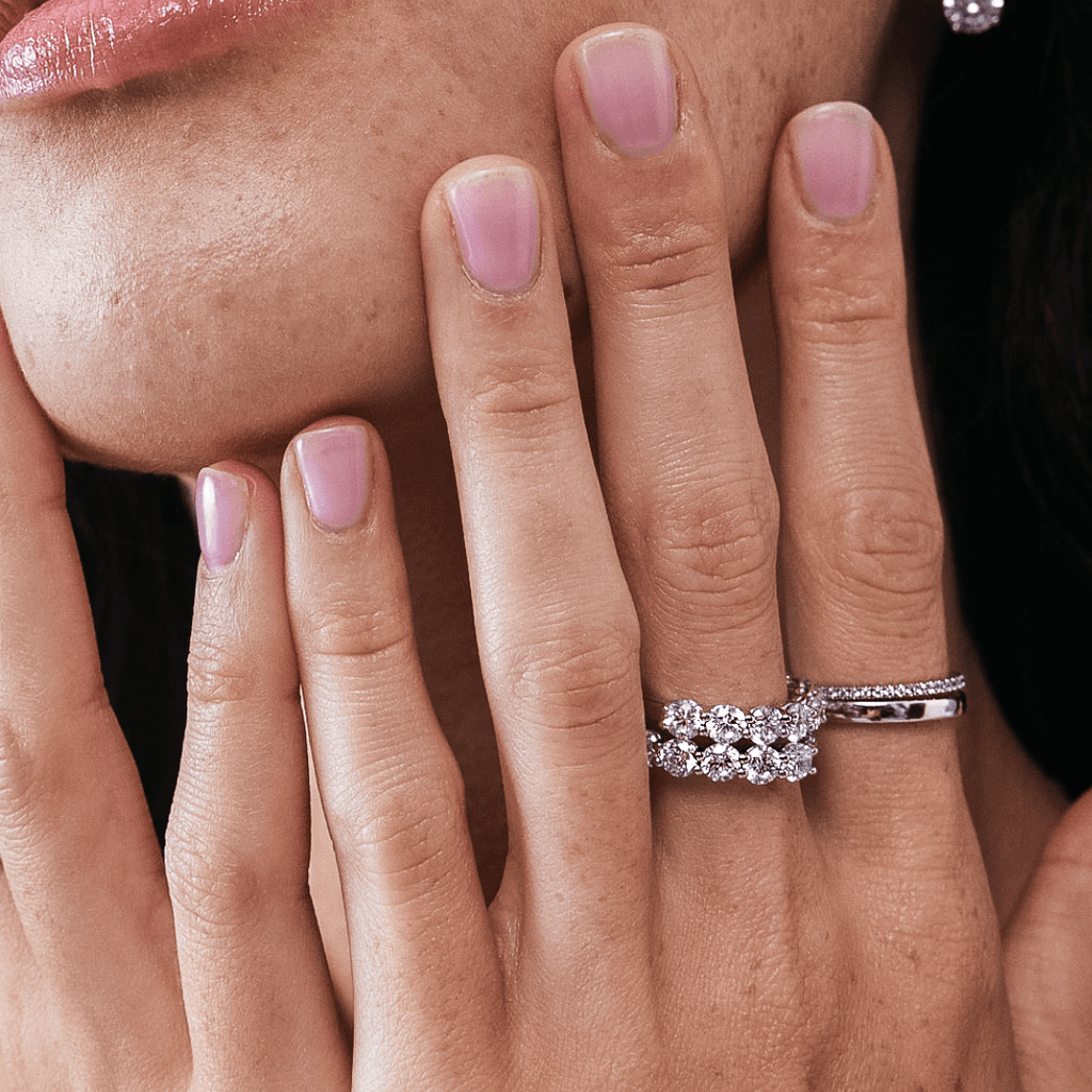 Close Up Of Diamond Eternity Rings On Finger